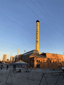 a brick building with a yellow tower that says columbus