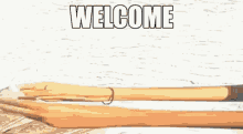 a cartoon drawing of a hand holding a fishing hook with the words welcome written on it