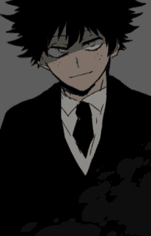 a boy with green eyes is wearing a suit and tie .