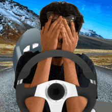 a man covering his face with his hands while driving