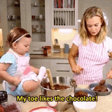 a little girl sits on a counter next to a woman who says my toe likes chocolate