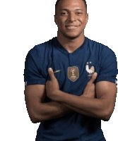 a man with his arms crossed wearing a blue shirt that says fifa on it