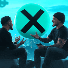 two men are sitting in front of a green ball with an x in the middle