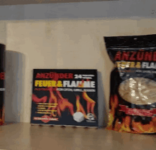 a bag of anzunder feuer & flamme sits next to a book