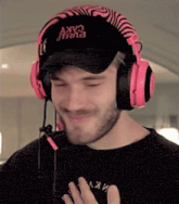 a man wearing headphones and a hat that says akv on it .