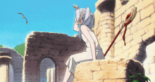 a woman in a white dress is sitting on a brick wall with a sword in her hand