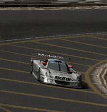 a silver race car with a bmw logo on the front