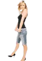 a woman in a black tank top and denim shorts is standing in front of a white background