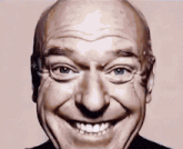 a close up of a man 's face with a big smile on it