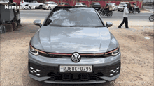 a grey volkswagen car with a license plate that says rj60cf075