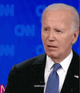 a man in a suit and tie is making a confused face while talking on cnn