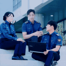 a group of police officers are sitting on a set of stairs with one holding a laptop that says samsung