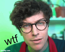 a man wearing glasses and a scarf has the word wtf written on his face