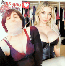 two women are posing for a picture with a kiss you sign behind them
