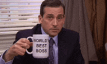 michael scott from the office is holding a mug that says `` world 's best boss '' .