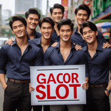 a group of young men holding a sign that says gacor slot