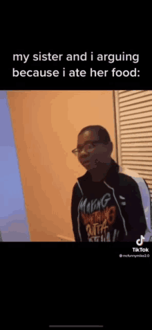 a woman is standing in front of a wall wearing glasses and a hoodie that says making something outta it .