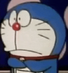 a close up of a cartoon character with a red nose covering his face .