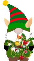 a gnome wearing a green and red striped hat holds a christmas tree