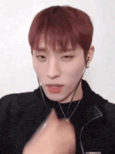 a close up of a person wearing headphones and a black jacket