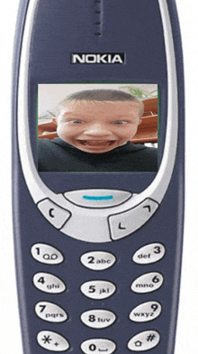 a nokia cell phone with a picture of a child on the screen