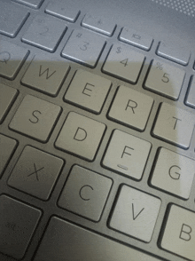 a close up of a keyboard with the letters s d f g x c v b visible