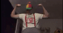 a blurry image of a man wearing a hat and suspenders