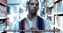 a man is standing in a store holding a bottle of wine and talking about weed , white wine .