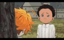 a young boy with a sad look on his face stands next to a girl with orange hair