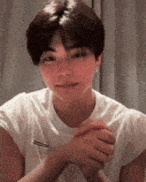 a young man wearing a white t-shirt with the word ramen on the front