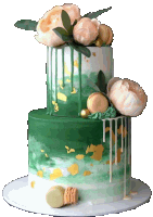 a green and white cake with flowers and gold leaf