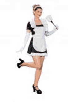 a woman in a maid costume is holding a duster and standing on one leg .