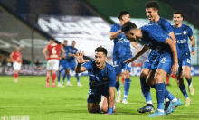 a group of soccer players wearing blue shirts with the word salto on the front