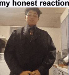 a man in a suit and tie stands in a kitchen with the words " my honest reaction " behind him