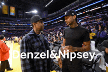 two men are talking in a stadium with the words denzel & nipsey on the bottom right