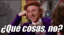 a man wearing a top hat and a purple jacket is talking to another man in spanish .