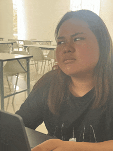 a woman wearing a black shirt that says ' aa ' on it