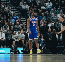 a philadelphia basketball player is standing on the court