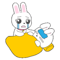 a cartoon bunny is crying while holding a cell phone