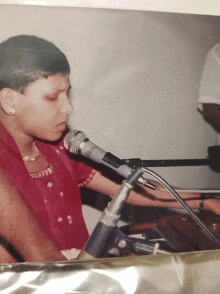 a young girl singing into a microphone that says shure