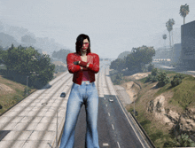 a woman in a red jacket is standing on a highway with her arms crossed