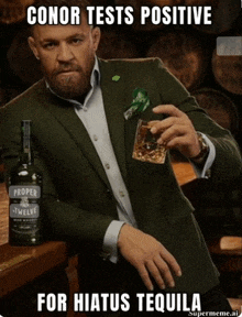 a man in a suit is holding a glass of whiskey and a bottle of proper twelve