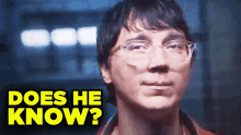 a close up of a man with glasses and the words " does he know " below him