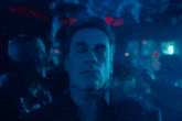 a man with his eyes closed in a crowd
