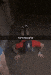 a man in a red shirt is doing push ups and the caption says mom im scared