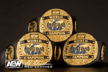 three aew world champion belts are stacked on top of each other