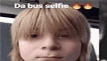 a close up of a person 's face with the words `` da bus selfie '' written above it .