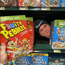 a box of fruity pebbles cereal sits on a shelf