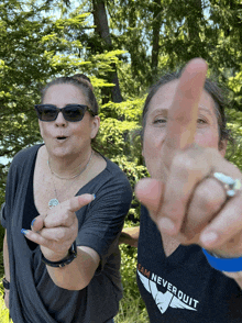 a woman wearing a black shirt that says team never quit