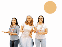 three women are posing for a picture with one wearing a white shirt that says ' i love you ' on it